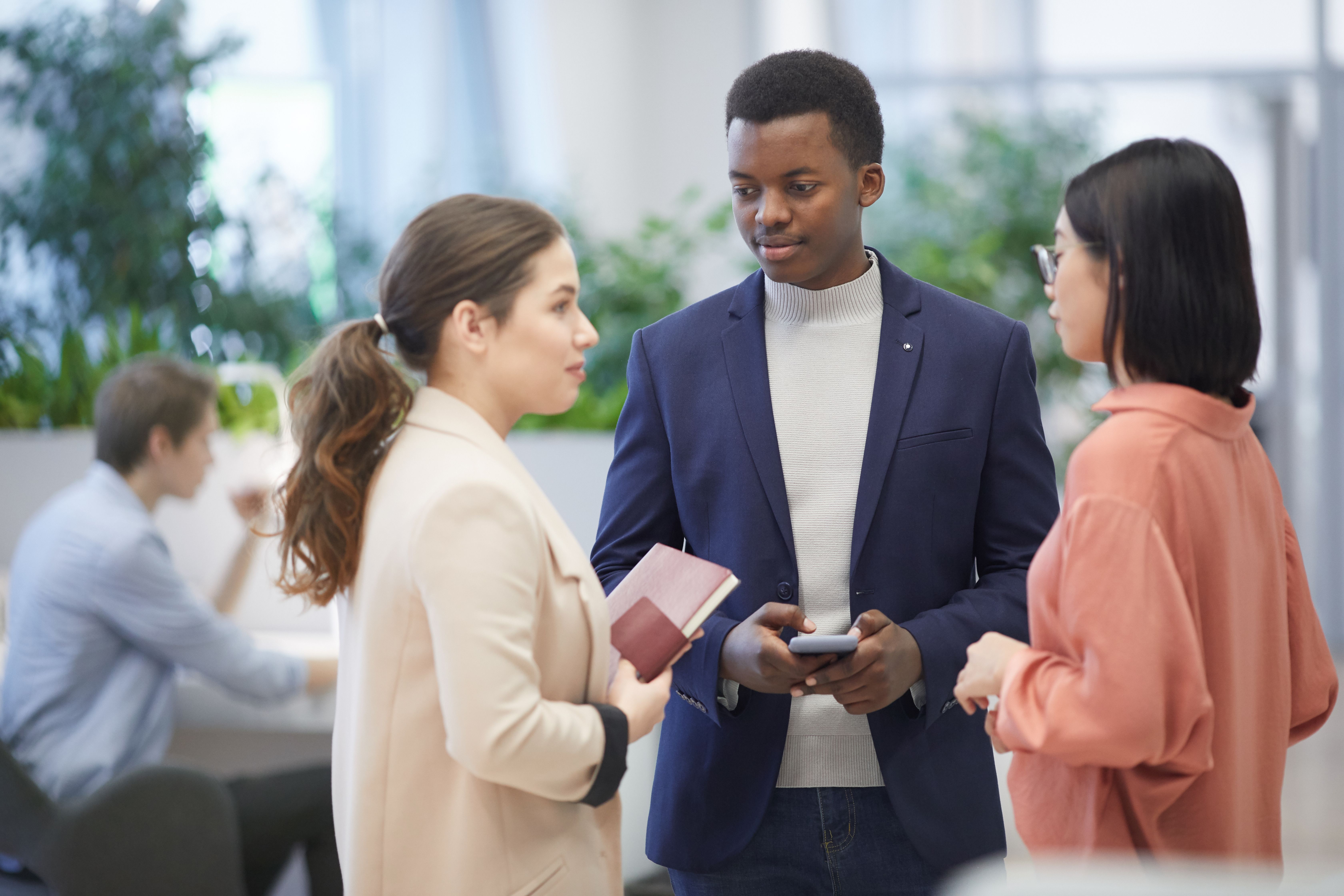 african businessman talking to colleagues in office