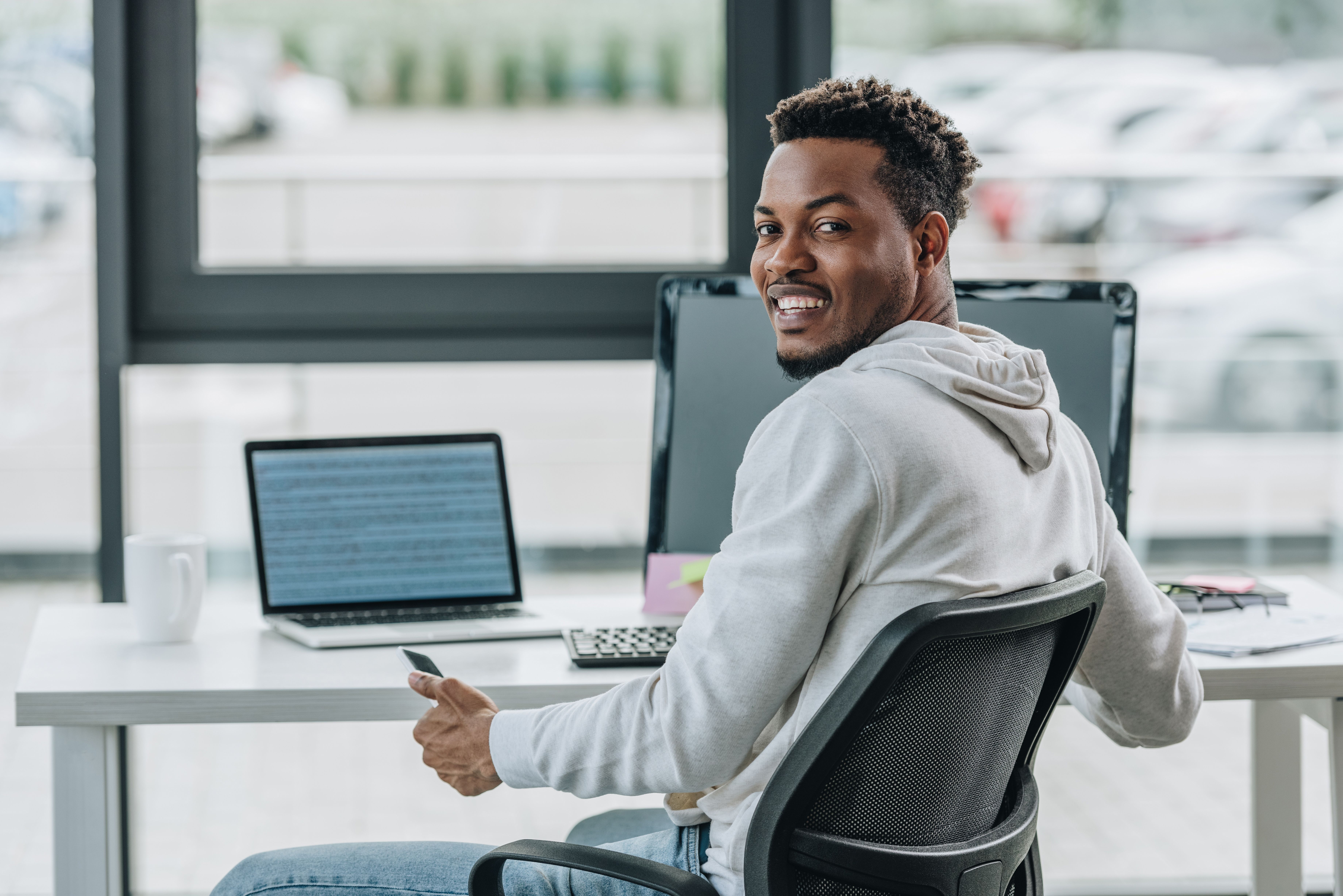 happy african american programmer smiling at camera